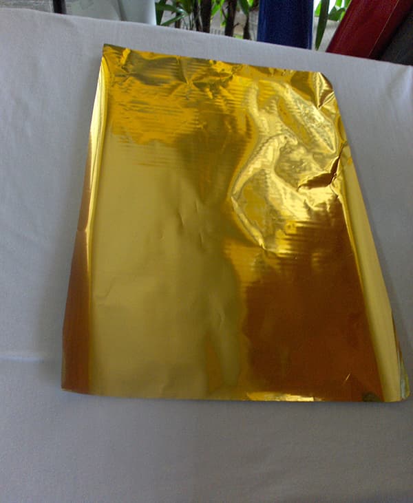 Foil Printing Step 4: Placing Foil Over Adhesive Ink by ScreenPrintingNow Step 4: Placing foil over adhesive ink by ScreenPrintingNow